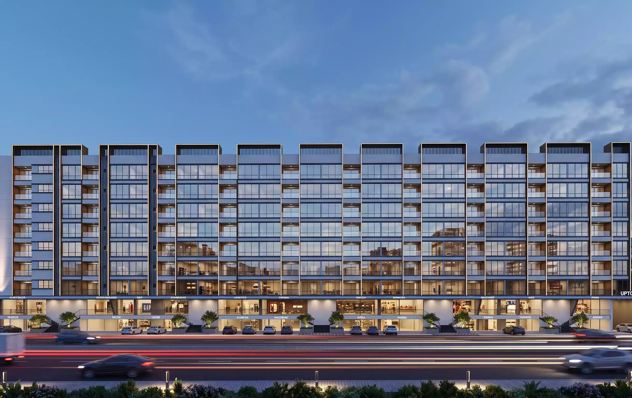 Uptown Plaza by GreeNest - front elevation lit at night above the Ambegaon high street
